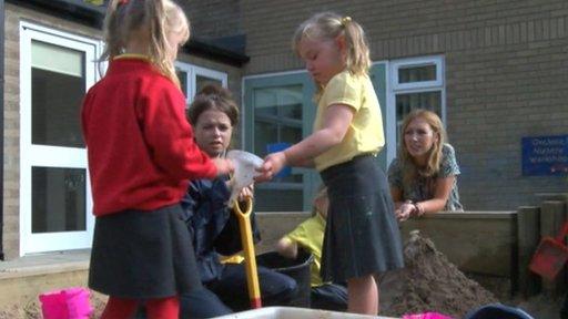 Nursery school children playing in sandpit