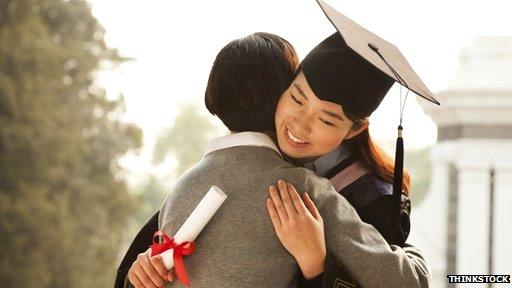 graduate hugging parent