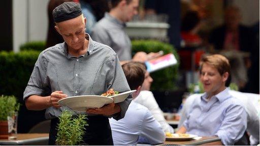 Waitress clearing tables