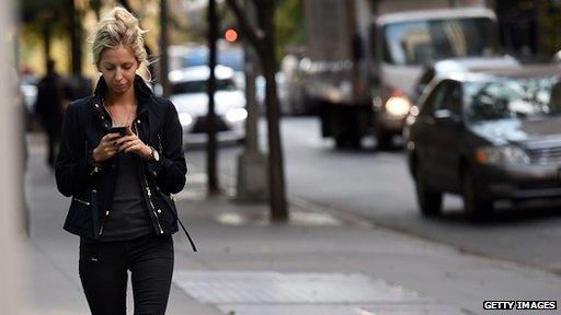 woman using her phone in the street