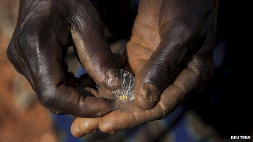 Man showing mined gold