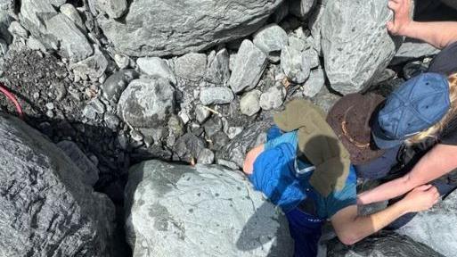 The rock on top of the man in the creek
