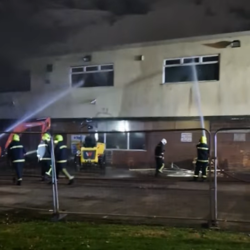 Firefighters can be seen spraying water into the windows of the a two-storey white building - the Low Grange social club. 