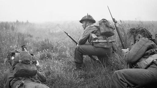 three soldiers hiding in a field