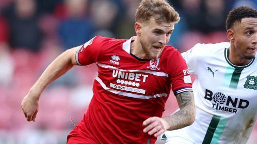 Riley McGree of Middlesbrough battles for possession with Brendan Galloway of Plymouth Argyle during the Sky Bet Championship match between Middlesbrough and Plymouth Argyle at Riverside Stadium on February 24, 2024 in Middlesbrough, England