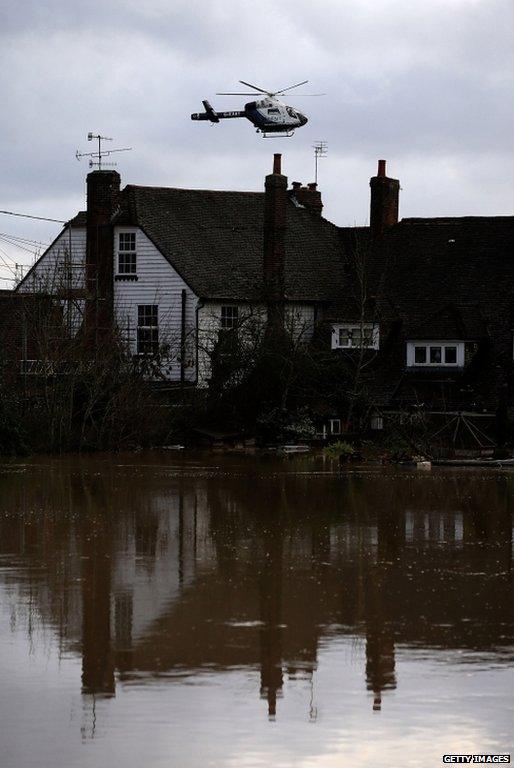 A helicopter above flood water