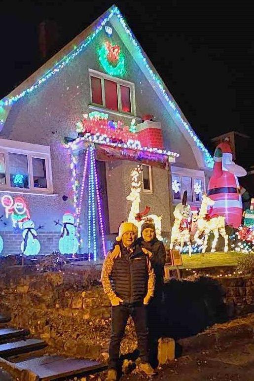 Dave with his son in front of house