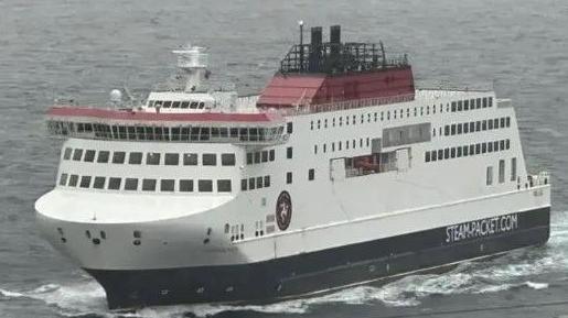 The Manxman ferry, which is painted in white, red and black on choppy waters. it has Steam-Packet.com and the firm's logo on the side.