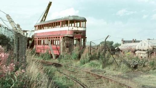 A scrapyard in Leeds in 1967, showing the remains of an old tram. The photo was taken from the trackbed of the former tramway through the woods where it crossed the colliery railway. 