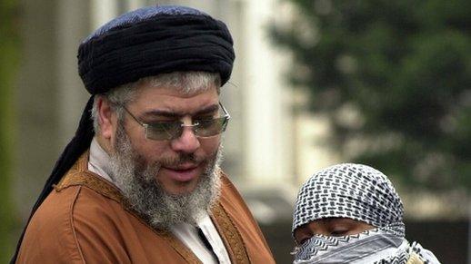 Abu Hamza Al-Masri is embraced by one of his supporters outside the Finsbury Park Mosque during Friday prayers 21 March 2003