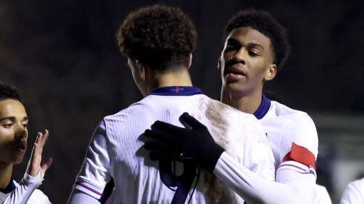 Ethan Wheatley and celebrate an England goal