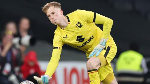 Filip Marschall rolls the ball out for MK Dons