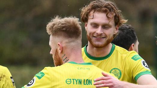 Zach Clarke (R) celebrates with Bradley Young