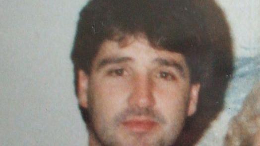 A family handout photo of Peter Warren. He has brown hair and stubble on his face.