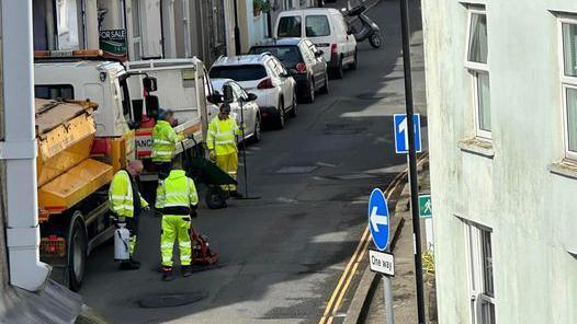 Workers filling in potholes