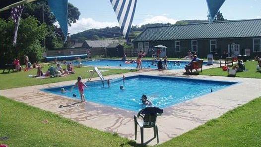 Paddling pool in foreground with main pool further away