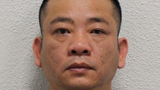 Custody image of Hai Nguyen in front of a white wall, with a serious expression and cropped close to his face