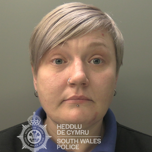 A mugshot of Claire Jones. She has short white hair and has a nose and lip piercing. 