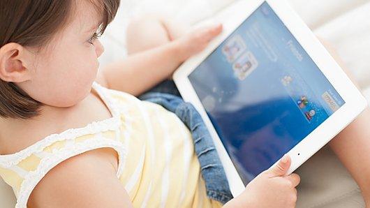 Young child playing with a tablet computer