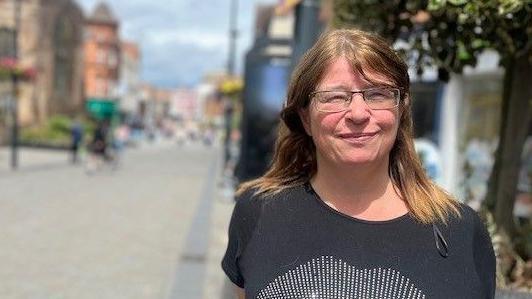 A woman stood outside in St Peters Street near the church