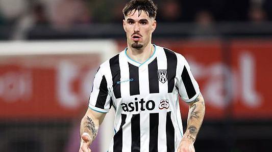 Ivan Mesik in black and white striped Heracles shirt