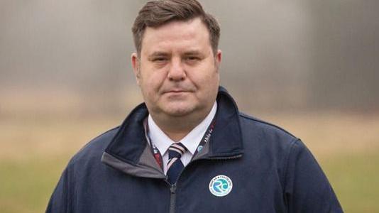 Council leader Alec Brown. He has dark hair and is clean shaven.