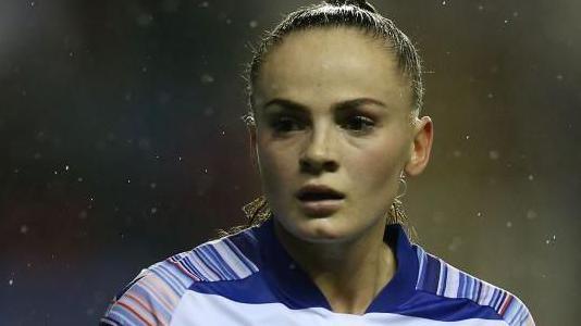 Lily Woodham pictured while playing for Reading, wearing a blue and white Reading home shirt 