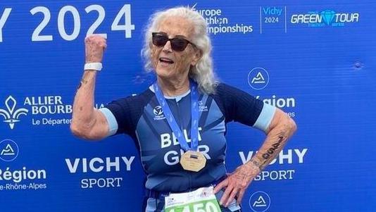 Daphne Belt poses with her medal after winning her age category in Vichy, France