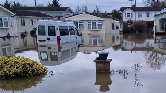 The picture shows residential caravan homes and a van under water at the Primrose Hill site near Somerton.  The photo was taken when the site flooded in 2023.