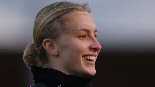 An England footballer smiling