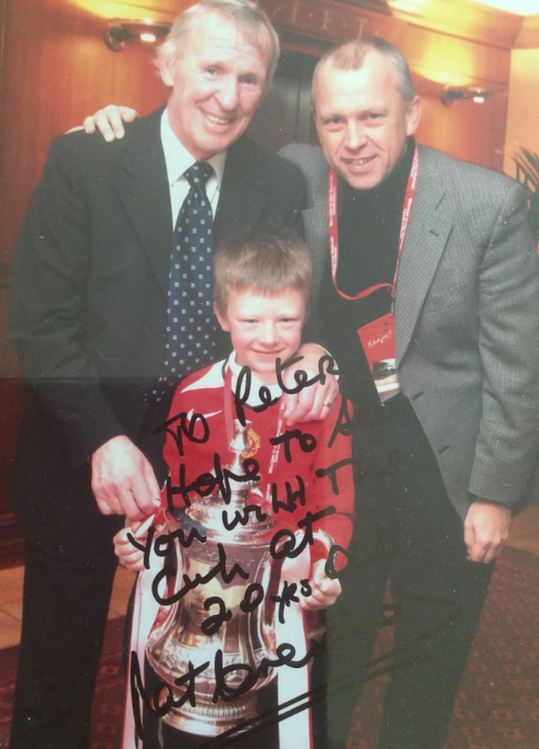 Eight-year-old Peter Boyle holding the FA Cup with a signed message from former Manchester United player Paddy Crerand "hope to see you with the cup at 20". On Friday striker Boyle, 20, is set to make his 100th appearance for Hyde United in the FA Cup tie with MK Dons