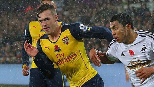 Jefferson Montero of Swansea and Calum Chambers of Arsenal in a chase for the ball