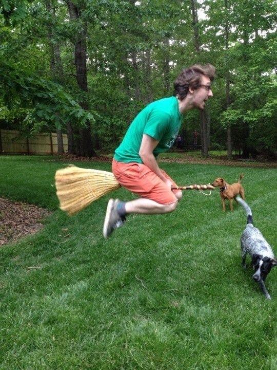 Man jumps with broom between his legs to mimic flying