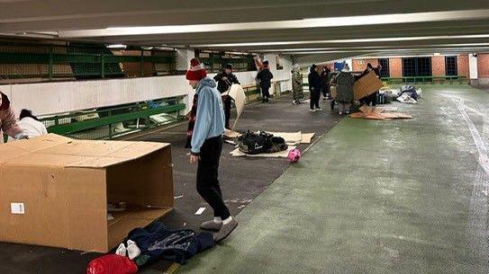 Another picture of volunteers assembly their cardboard boxes for the night.