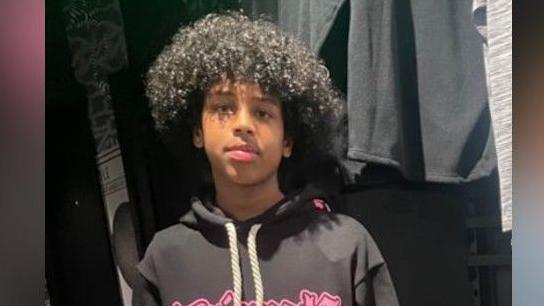 Mohanad Abdullaahi Goobe. He had black curly hair and was pictured wearing a dark hoodie with bright pink writing on it.