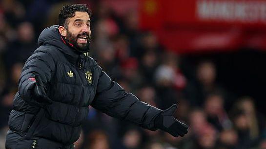 Ruben Amorim with his arms outstretched