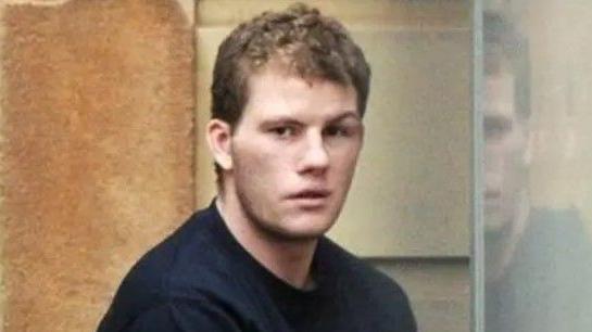 Shane Frane pictured at a previous hearing. He is wearing a dark jumper and has short brown curly hair. 