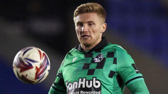 Taylor Moore watches the ball in action for Bristol Rovers against his old club Shrewsbury Town in March 2025.