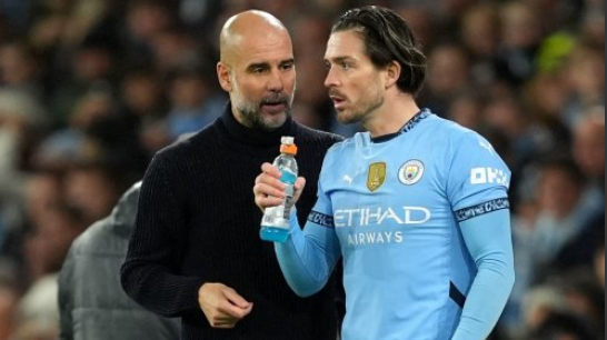 City manager Pep Guardiola talks to Jack Grealish on the touchline before he comes on as a sub against Spurs