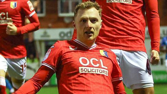 George Maris of Mansfield Town is celebrating after scoring, making it 1-0, during the Sky Bet League 2 match between Stockport County and Mansfield Town at Edgeley Park Stadium in Stockport, on January 1, 2024.