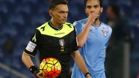 Referee Massimiliano Irrati holds the ball after stopping play