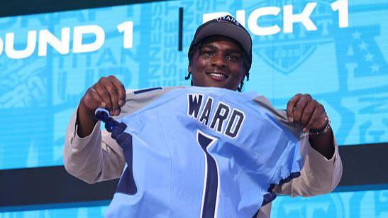 Cam Ward holds a Tennessee Titans jersey aloft after being selected first in the 2025 NFL Draft