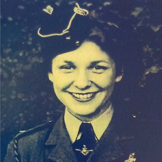 Mary Cliff, smiling while wearing a Navy uniform in a black and white image