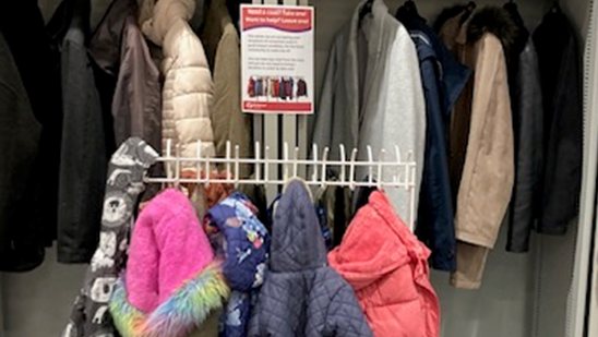 Coats donated to the Somerset libraries coat exchange scheme hanging on rails