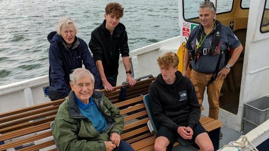 A group of people onboard an electric ferry