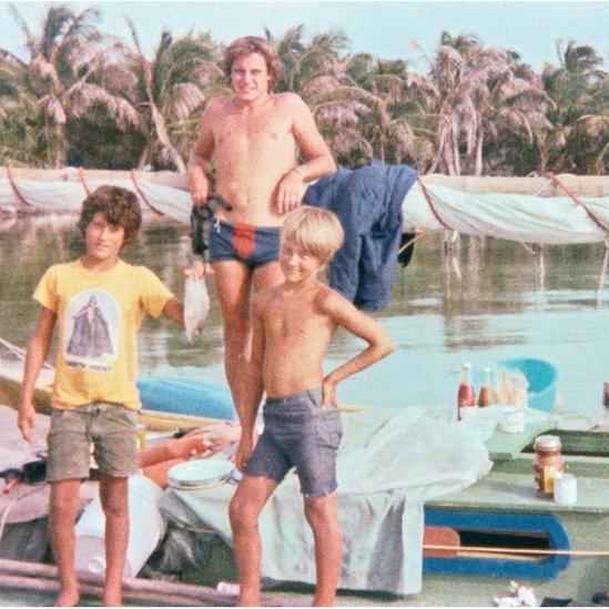 Photo of Chris, Russel, and Vince on the Justin B boat, holding a fish.