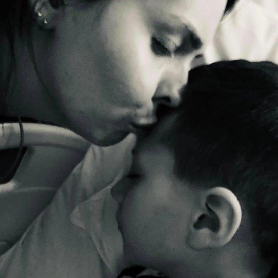 Sara Watson kissing her son in hospital