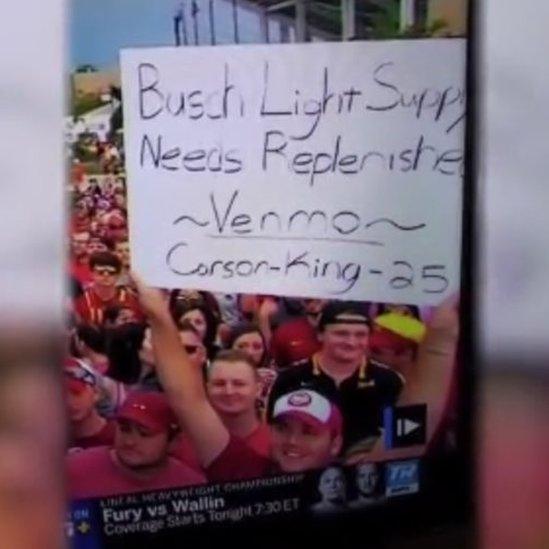 Mr Carson holding his sign on TV