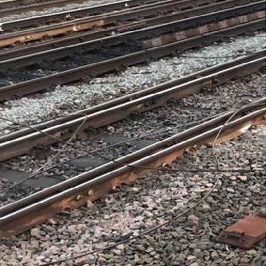 Damaged cables lay across railway track in Wembley