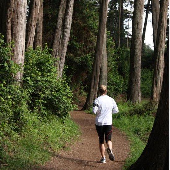 Woman running in woods